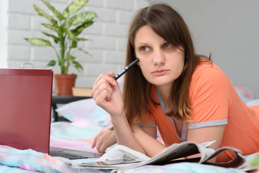 The girl thought while lying in front of a laptop in search of work