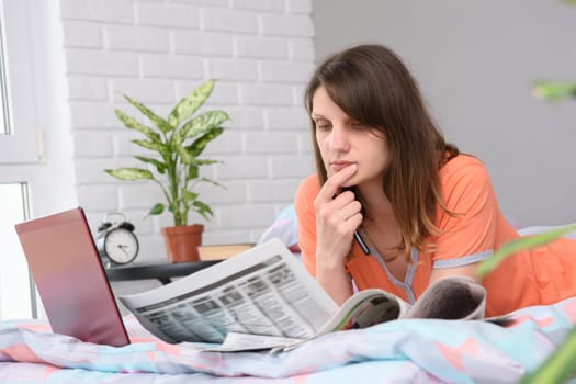 Girl thoughtfully reads with job offers announcements
