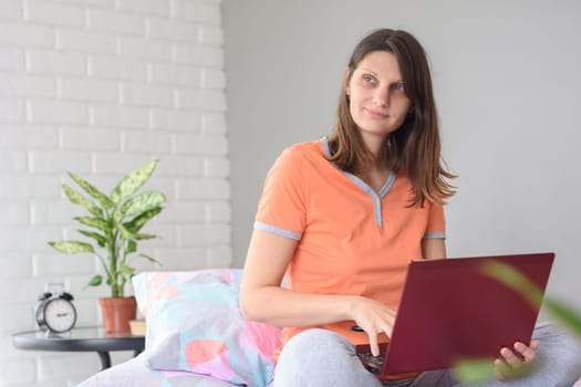 Girl working at home in a laptop distracted and looked out the window