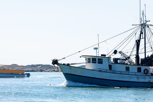 Old fishing boat navigating the Brazos Santiago Pass from the Laguna Madre into the Gulf of Mexico