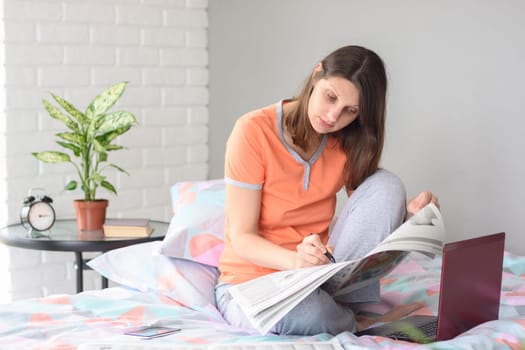 Girl marks the right advertisement in the newspaper while looking for work