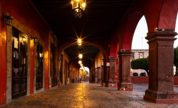 Corridor with arches, where at night is full of tourists eating at  the restaurants, is empty early in the morning at San Miguel de Allende, Guanajuato, Mexico
