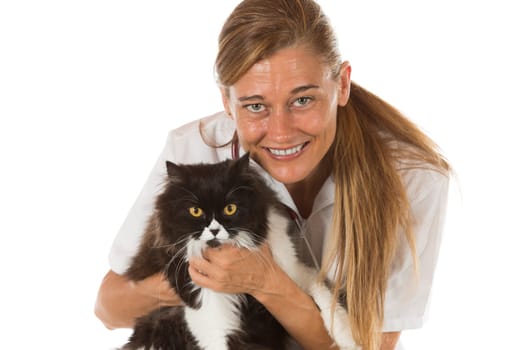 Veterinary hugging a cat and reassuring for review