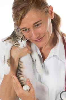 Veterinary hugging a cat and reassuring for review