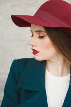 Young beautiful Woman Profile Portrait. Woman in a red hat on her head, Beautiful Face and soft Skin