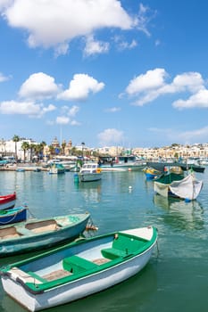Marsaxlokk village harbor of Malta, Mediterranean traditional colorful boats luzzu. Island of Malta.