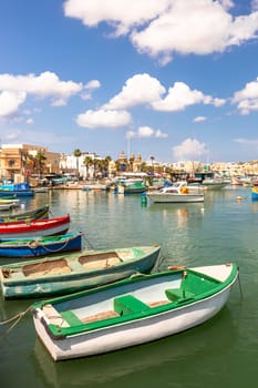 Marsaxlokk village harbor of Malta, Mediterranean traditional colorful boats luzzu. Island of Malta.