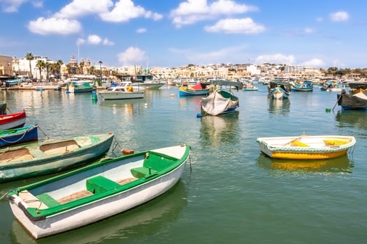 Marsaxlokk village harbor of Malta, Mediterranean traditional colorful boats luzzu. Island of Malta.