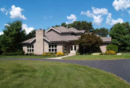 Single family brick contemporary home with a circle drive.