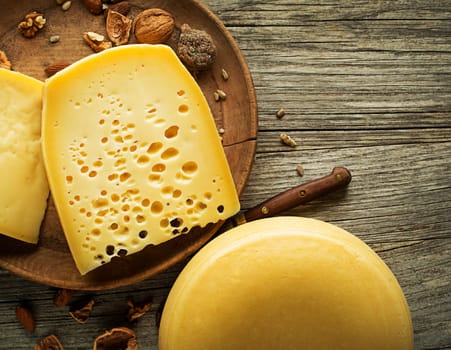 Various kind of hard cheese served on wooden table, traditional pieces of hand-made cheese. Copyspace for text
