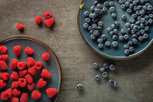 Colorful assorted of blueberry and raspberry. Berries overhead closeup
