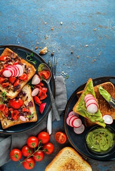 Breakfast served with toast sandwiches with avocado spread, tomato, onion and herbs.