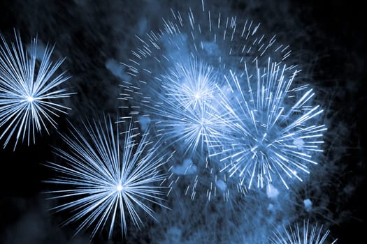 Premium entertainment magic star firework at e.g. New Years Eve or Independence Day party celebration. Black dark night background.