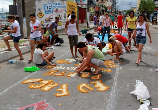 Itabuna, Bahia / Brazil - June 7, 2012: People are seen making traditional tapes during the Corpus Crist holiday festivities in Itabuna.