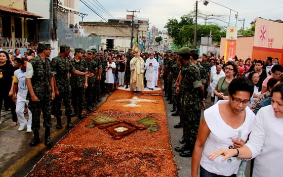 Itabuna, Bahia / Brazil - June 7, 2012: People are seen during procession upon traditional tapes during the Corpus Crist holiday festivities in Itabuna.