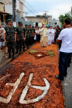 Itabuna, Bahia / Brazil - June 7, 2012: People are seen during procession upon traditional tapes during the Corpus Crist holiday festivities in Itabuna.