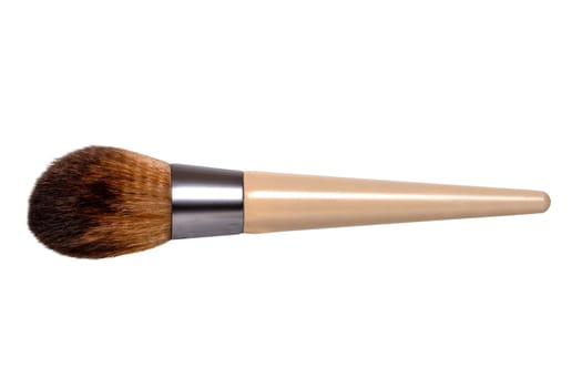 Closeup of a wooden new professional makeup brush isolated on a white background. Concept beauty. Macro photograph.