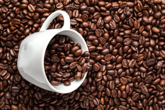 A White cup with coffee beans on a background of coffee beans