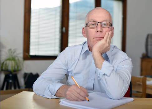 a serious mature businessman in office