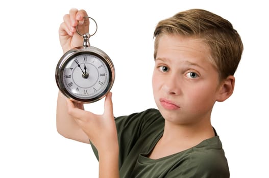 Lateral head-and-shoulders view of a 12-year-old Caucasian boy with his right hand holding an oversized pocket watch with a pointer 5 minutes to 12 and looking disappointedly at the camera isolated on white.