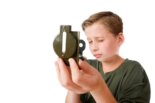 Frontal torso view of a 12 year old Caucasian boy with a compa on his right hand aiming an imaginary target towards the camera isolated on white.