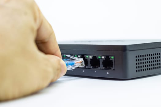 Hand of man holding The network cables to connect Lan port, concept Communication connection technology