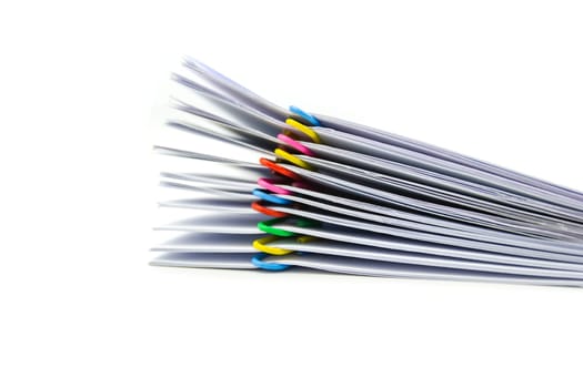 close up of Stack of papers files piles of unfinished documents achieves with paper clips .