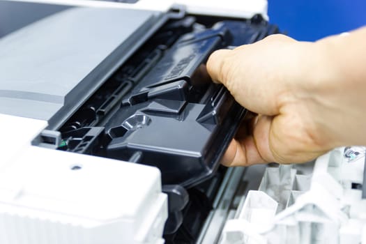 Technicians replacing toner in laser printer concept office supplies repair