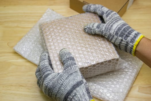 hand of man hold bubble wrap, for protection parcel product cracked or insurance During transit