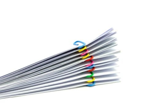 close up of Stack of papers files piles of unfinished documents achieves with paper clips .