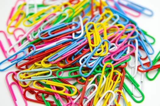 Collection of colorful Paper clips on white background..
