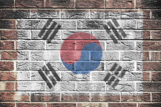 A South Korea flag on brick wall background.