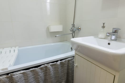 Small budget bathroom with a small washbasin