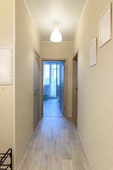 Corridor in a one-room apartment, a balcony in the distance