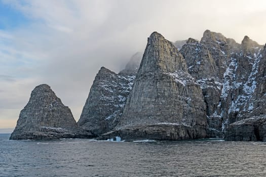 Dramatic Cliff Emerging from the Fog near Sunneshine Fjord on Baffin Island in Nunavut, Canada