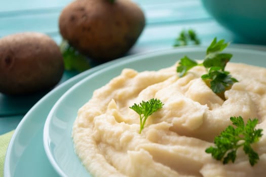 Rustic mashed potatoes with greens in bowl closeup