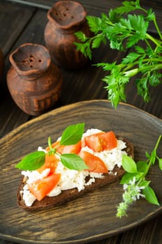 Bruschetta with ricotta cheese, fresh basil and tomato. Vertical image