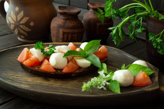 Bruschetta with tomatoes, mozzarella and basil. Traditional italian appetizer or snack