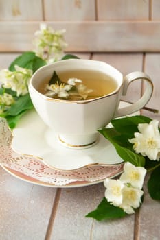 Jasmine herbal tea on a shabby wooden table, vertical image
