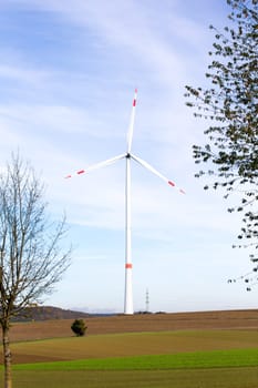 A Wind turbine with a blue sky in the background