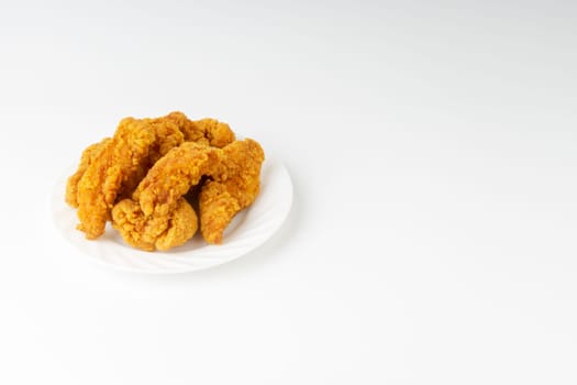 Fried breaded chicken fillet isolated on white background