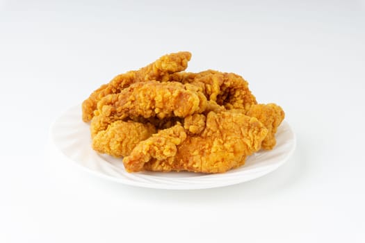 Fried breaded chicken fillet isolated on white background