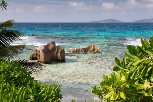Seychelles with a turqouise water and big stones and lot of green plants
