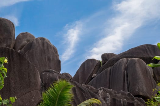 Blue sky with some clouds and big stones in front
