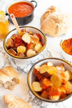 Delicious bratwurst with a spicy tomato curry sauce