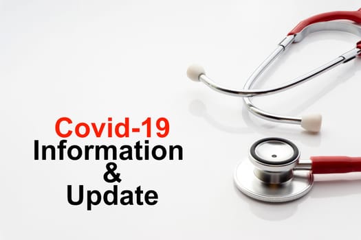 COVID-19 INFORMATION AND UPDATE text with stethoscope on white background. Covid or Coronavirus Concept