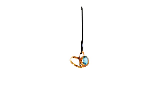 Wedding Ring On A Fishing Hook Isolated On White Background
