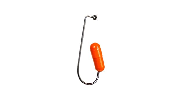 Orange Pill On A Fishing Hook Isolated On White Background