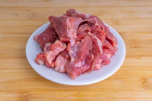 Fresh raw beef steak on wooden background with selective focus