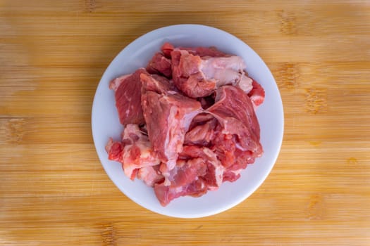 Fresh raw beef steak on wooden background with selective focus